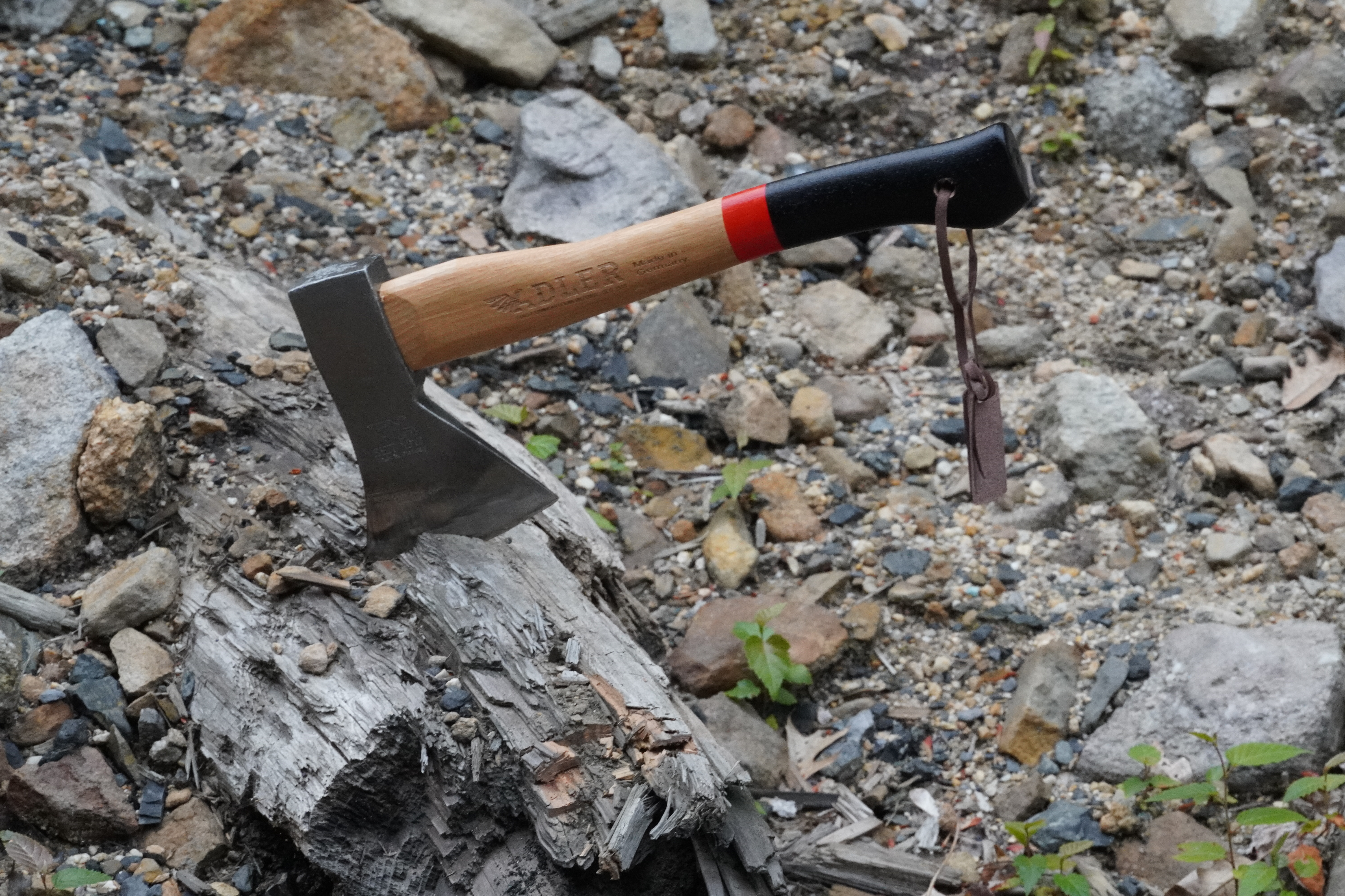An axe stuck in an old log.
