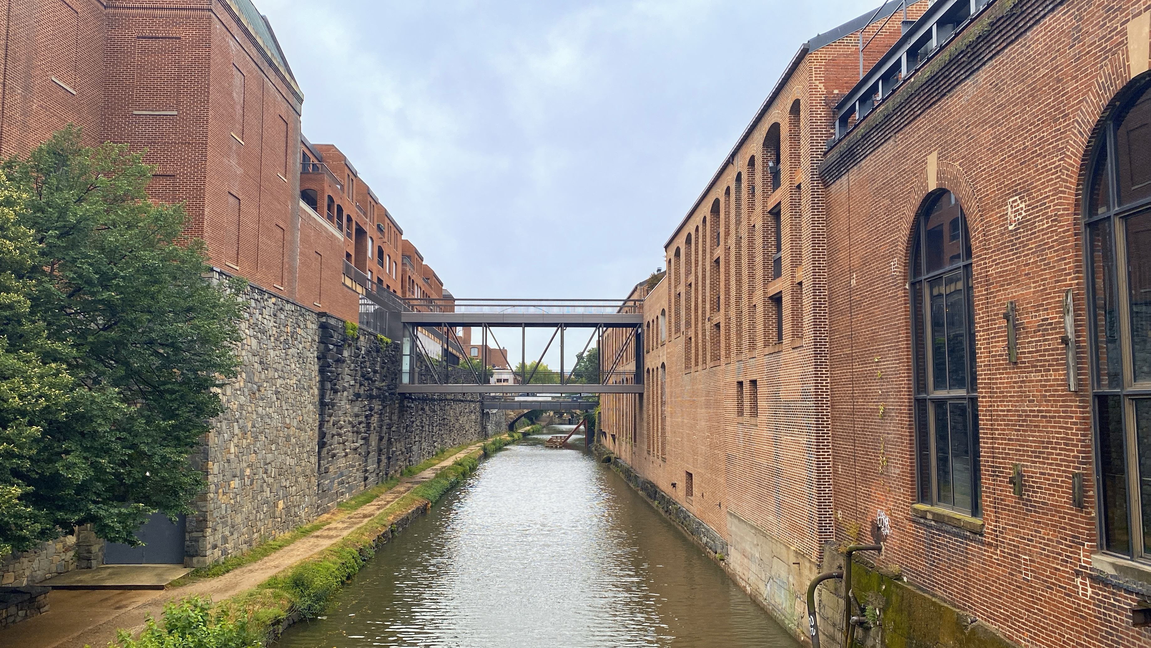 Old brick buildings lining a narrow canal.