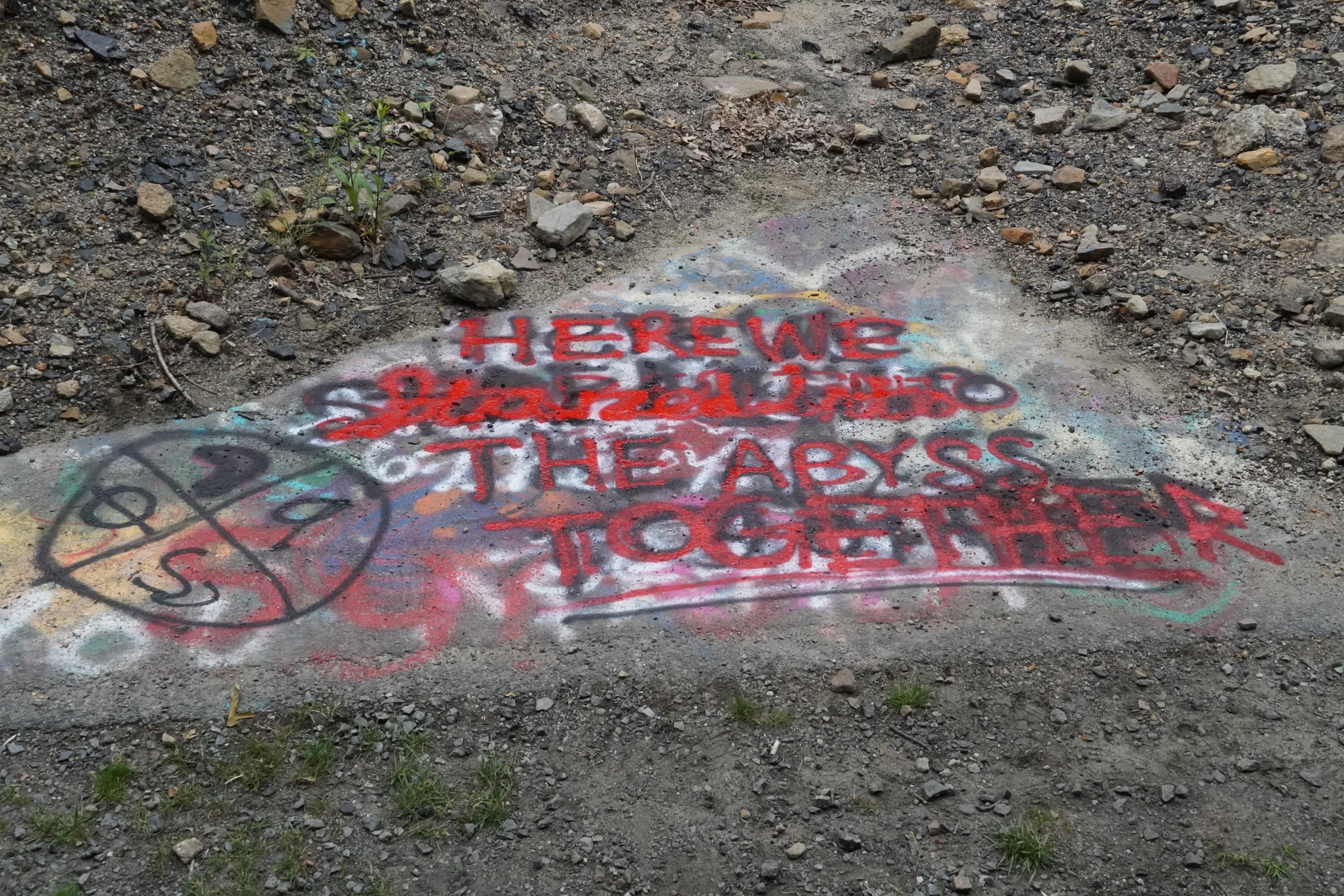 Graffiti reading 'Here we stared into the abyss together'.