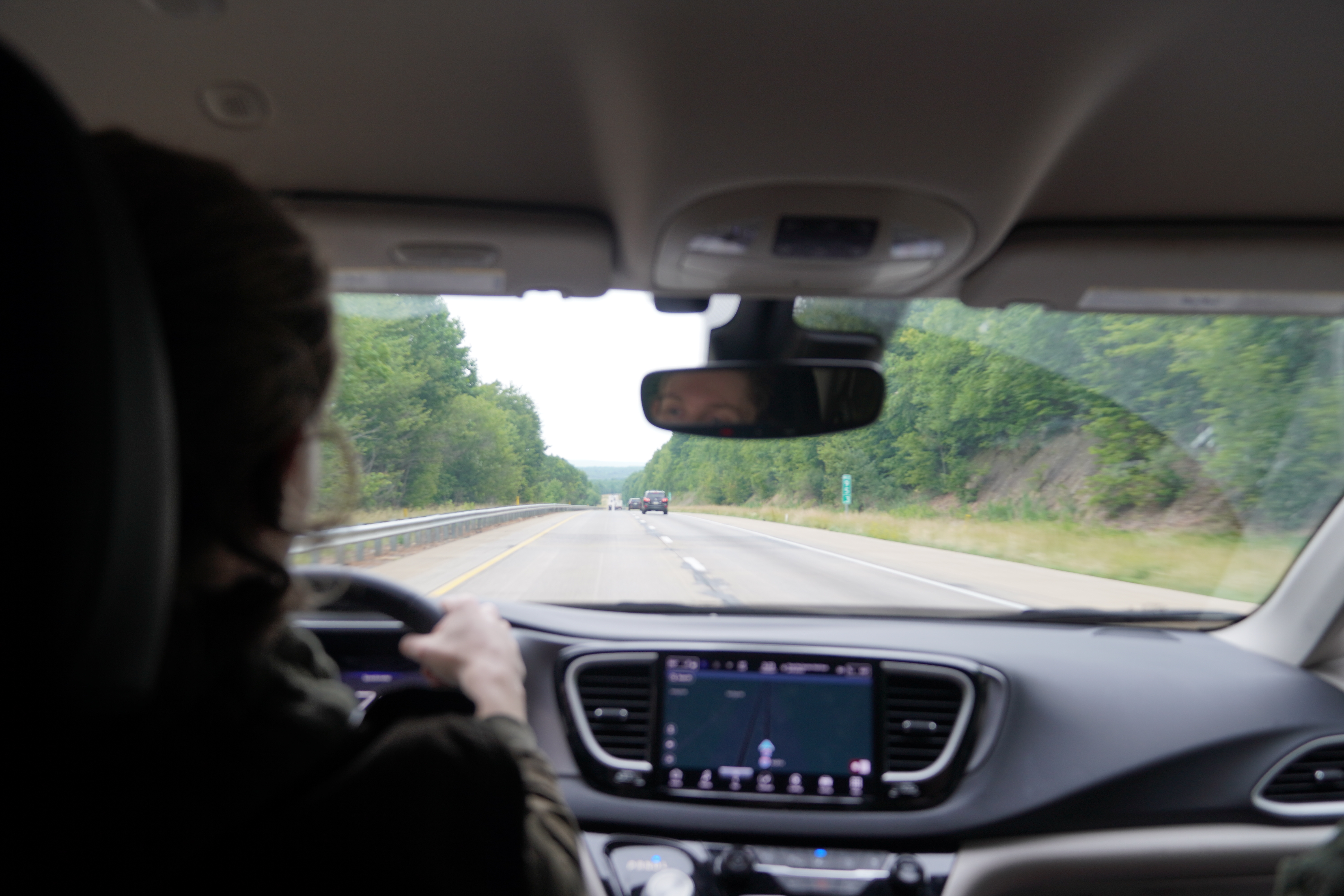 The group driving down a rural highway.